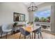 Bright dining area featuring wood floors, a large window, and a modern chandelier at 7696 S Hudson Way, Centennial, CO 80122