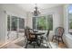 Bright dining area with backyard views and an elegant chandelier above the round table at 7696 S Hudson Way, Centennial, CO 80122