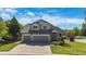 Charming two-story home with a well-manicured lawn and a two-car garage at 7696 S Hudson Way, Centennial, CO 80122