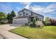 Attractive two-story house with a landscaped lawn and a two-car garage at 7696 S Hudson Way, Centennial, CO 80122