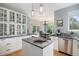 Open kitchen layout with a view of the dining area, stainless appliances, and a center island at 7696 S Hudson Way, Centennial, CO 80122