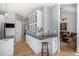 Bright kitchen showcasing updated cabinets, countertops, and views into the living area at 7696 S Hudson Way, Centennial, CO 80122