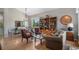 Open living space with hardwood floors, a dining area, and large windows at 7696 S Hudson Way, Centennial, CO 80122