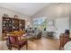 Cozy living room with hardwood floors, vaulted ceilings, and a large window at 7696 S Hudson Way, Centennial, CO 80122
