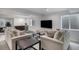 Basement living room with wet bar, large TV, and neutral-toned furniture at 7696 S Hudson Way, Centennial, CO 80122