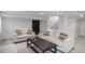 A basement living room showcases neutral furniture, and a dark accent door with access to stairs at 7696 S Hudson Way, Centennial, CO 80122