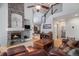 Cozy living room with a stone fireplace, hardwood floors and stairs at 7696 S Hudson Way, Centennial, CO 80122