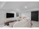 Basement living room featuring a large flat screen television, neutral furniture and a sliding door at 7696 S Hudson Way, Centennial, CO 80122