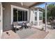 Back patio area offering comfortable seating and a view of the landscaped backyard at 7696 S Hudson Way, Centennial, CO 80122