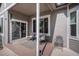 Inviting covered patio with brick flooring, seating, and sliding glass door access to the home at 7696 S Hudson Way, Centennial, CO 80122