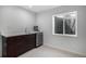 A modern wet bar area has a sink, mini fridge, marble counters and wood cabinets at 7696 S Hudson Way, Centennial, CO 80122