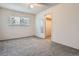 Carpeted bedroom features window and a closet, offering comfortable living space at 2215 E Geddes Ave # P08, Littleton, CO 80122