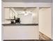 The kitchen offers countertop seating and an open view into the dining area at 2215 E Geddes Ave # P08, Littleton, CO 80122