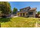 Spacious backyard with a patio, lush lawn, and a fenced perimeter, ideal for outdoor activities and relaxation at 1371 W 133Rd Way, Denver, CO 80234
