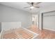 This bedroom offers a ceiling fan, wood floors, a door to the hallway, and a closet for storage at 1371 W 133Rd Way, Denver, CO 80234