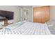 This bedroom features carpet floors, a sliding-door closet, and a TV on a wooden stand at 1371 W 133Rd Way, Denver, CO 80234