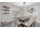 Well-lit dining room with a modern light fixture and a large wooden table at 1371 W 133Rd Way, Denver, CO 80234