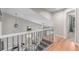 Hallway with views of the staircase, landing, and hardwood floors at 1371 W 133Rd Way, Denver, CO 80234