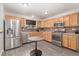 Functional kitchen features stainless steel appliances, wooden cabinets, and modern fixtures at 1371 W 133Rd Way, Denver, CO 80234