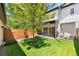 Fenced backyard features a lawn, patio area, and mature tree, creating a private outdoor space at 3103 S Cherokee St, Englewood, CO 80110