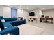 Finished basement with a large sectional sofa, desk area, and neutral decor at 3103 S Cherokee St, Englewood, CO 80110