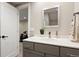 Modern bathroom with sleek vanity, quartz countertop, and open doorway to work out area at 3103 S Cherokee St, Englewood, CO 80110