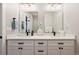 Bathroom showcasing a dual vanity with modern black fixtures and a bright, airy ambiance at 3103 S Cherokee St, Englewood, CO 80110