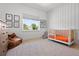 Bedroom with playful wallpaper, a modern crib, and a comfortable beanbag chair at 3103 S Cherokee St, Englewood, CO 80110