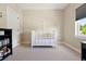 Bedroom with white crib, a modern cabinet, and plenty of room for a baby to sleep soundly at 3103 S Cherokee St, Englewood, CO 80110