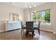 Dining room with modern chandelier, blue accent cabinet, and ample natural light at 3103 S Cherokee St, Englewood, CO 80110