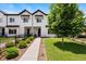 Charming exterior with black trim, showcasing the property's curb appeal and landscaped front yard at 3103 S Cherokee St, Englewood, CO 80110