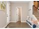Bright foyer with a bench, coat hooks, and view of the staircase at 3103 S Cherokee St, Englewood, CO 80110