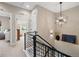 Upstairs hallway with geometric lighting and open doors at 3103 S Cherokee St, Englewood, CO 80110