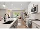 Open concept kitchen with stainless steel appliances and seamless access to outdoor living at 3103 S Cherokee St, Englewood, CO 80110