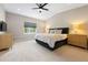 Main bedroom with a ceiling fan, natural light, and light wood furniture at 3103 S Cherokee St, Englewood, CO 80110