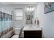 Bathroom features a vanity with a marble countertop and a shower with a patterned curtain at 17851 E 103Rd Ave, Commerce City, CO 80022