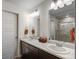 Bathroom with a double sink vanity with plenty of storage and mirrors that reflect natural light at 17851 E 103Rd Ave, Commerce City, CO 80022