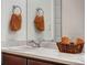 Bathroom sink with faucet, mirror, wall mounted towel hooks and basket at 17851 E 103Rd Ave, Commerce City, CO 80022