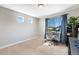 Home office with natural light, neutral carpet, desk, chair, and blue curtains at 17851 E 103Rd Ave, Commerce City, CO 80022