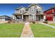 Attractive two-story home with a well-kept lawn, inviting porch, and pleasing curb appeal in a Gathering-friendly neighborhood at 17851 E 103Rd Ave, Commerce City, CO 80022