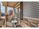 Inviting front porch with stone pillars and wrought iron seating, perfect for relaxing outdoors at 17851 E 103Rd Ave, Commerce City, CO 80022