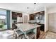 Bright kitchen with granite countertops, stainless steel appliances, and dark cabinets at 17851 E 103Rd Ave, Commerce City, CO 80022