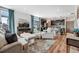 Open concept living room and kitchen with dark wood cabinets and hardwood floors, offering a cozy fireplace at 17851 E 103Rd Ave, Commerce City, CO 80022