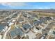 Wide aerial view of a modern neighborhood featuring a grid-like layout with well-kept yards, some snow, and various house styles at 4981 Liverpool St, Denver, CO 80249