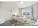 Charming bedroom with colorful decor, a rainbow rug, and bright windows at 4981 Liverpool St, Denver, CO 80249