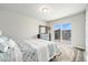 Comfortable bedroom featuring a sliding glass door to a balcony and neutral decor at 4981 Liverpool St, Denver, CO 80249