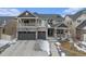 Beautiful two-story home with stone accents, a covered porch and two-car garage at 4981 Liverpool St, Denver, CO 80249