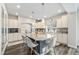 Elegant kitchen with modern appliances, a marble countertop island and seating for four at 4981 Liverpool St, Denver, CO 80249