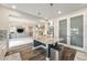 Spacious kitchen with an island featuring a granite countertop, a breakfast bar and a stainless steel refrigerator at 4981 Liverpool St, Denver, CO 80249