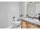Bathroom with a modern toilet and sink with gray countertop at 11029 Grouse Ct, Parker, CO 80134